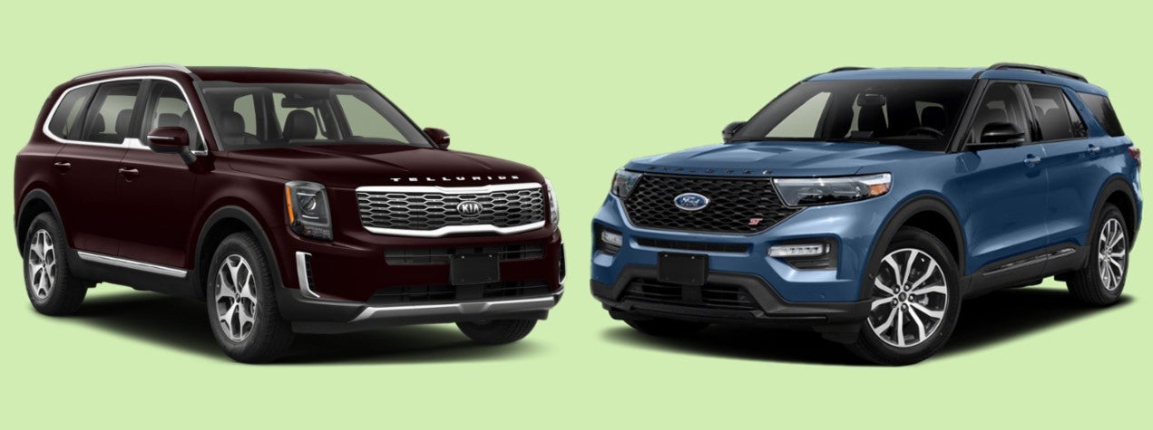 2021 Kia Telluride SUV in Sangria Red vs. 2020 Ford Explorer in Blue Metallic against Green Background