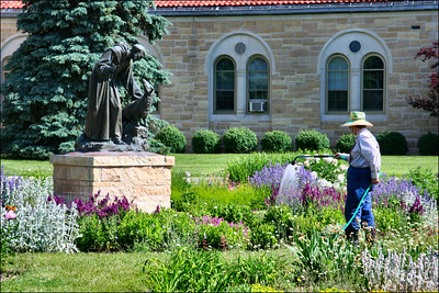 Gardener Watering Plants in Public Park in Rochester Minnesota