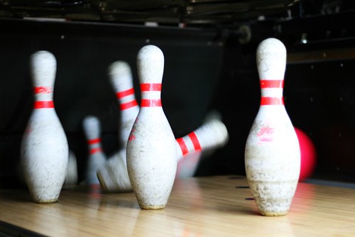 Bowling Pins Getting Knocked Down By Pink Bowling Ball