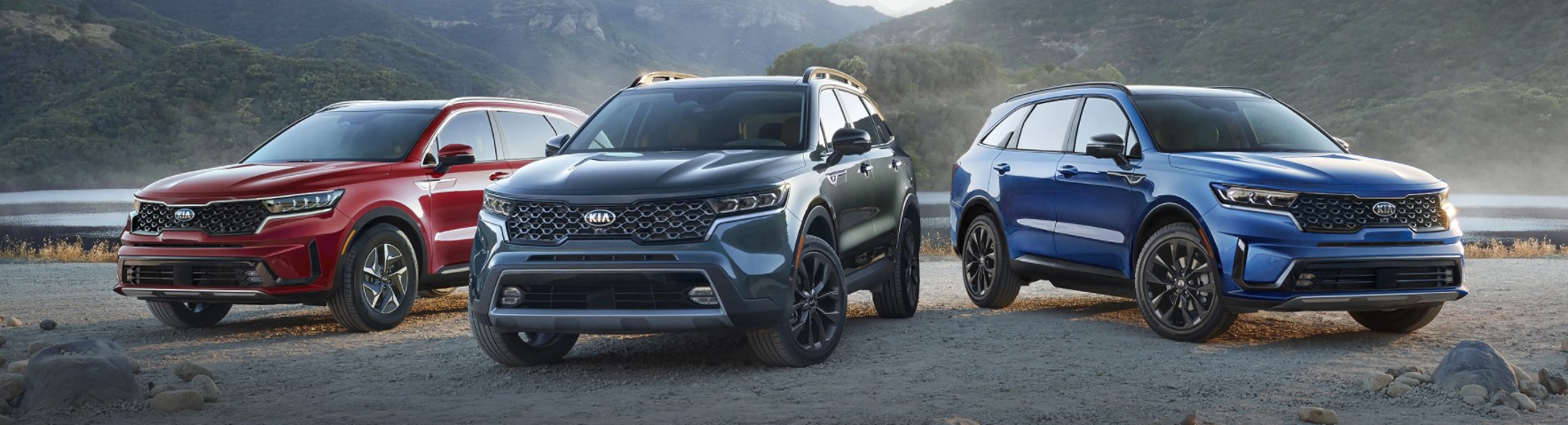 Collection of 2021 Kia Sorento SUVs in Different Colors against Mountainous Background