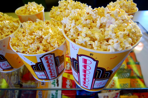 Movie Theater Popcorn above Glass Display Case of Candy