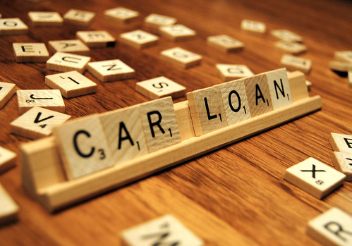 The Word 'Car Loan' Spelled Out with Scrabble Pieces on Wood Table
