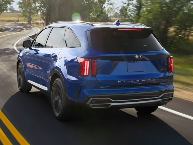 Exterior View of the 2021 Kia Sorento Racing Down a Winding Rural Highway