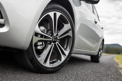 Tires and Rims of a Kia Sedan on Asphalt Road